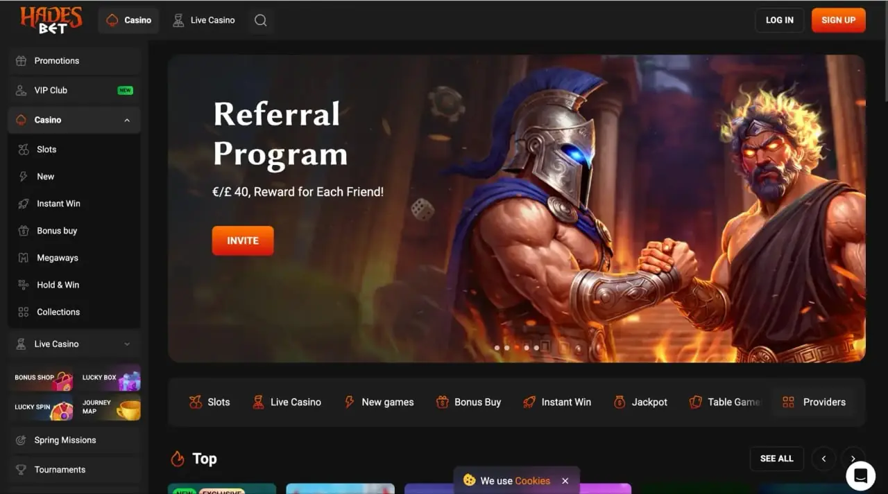 HadesBet casino homepage showing referral program hero and game categories